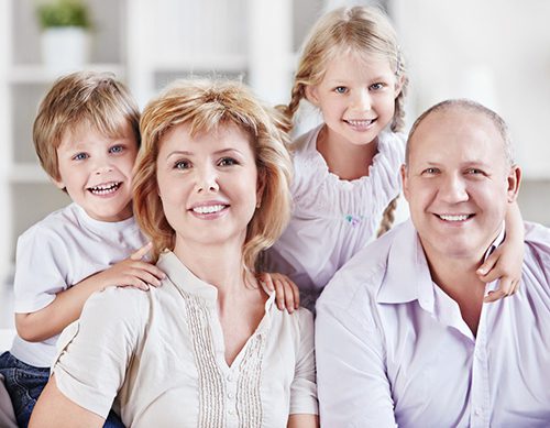 Portrait of a happy family all in white attire